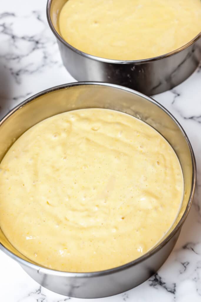 the batter for the Lemon Curd Cake in two cake pans ready to bake.