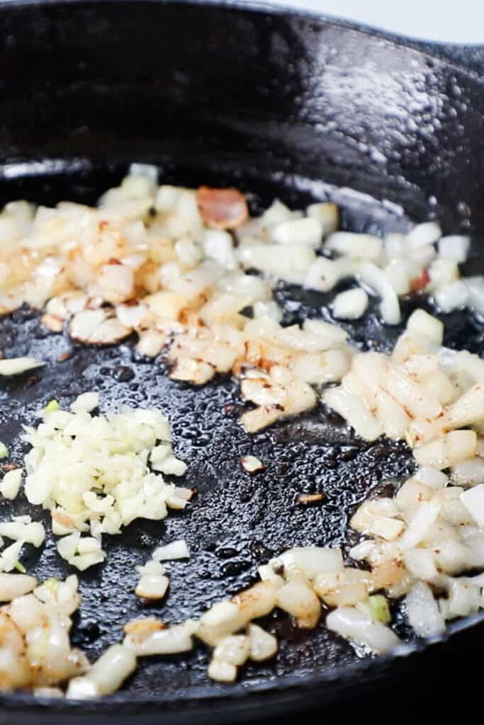 the garlic added to the skillet with the cooked onions.