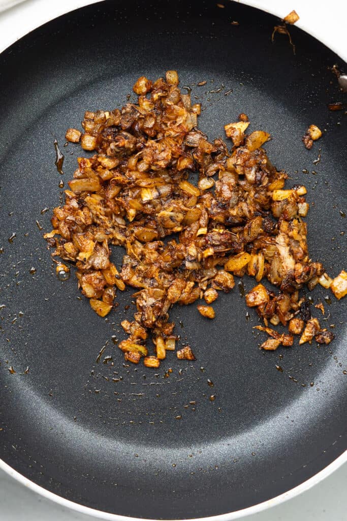 Onions cooking in a non stick pan.