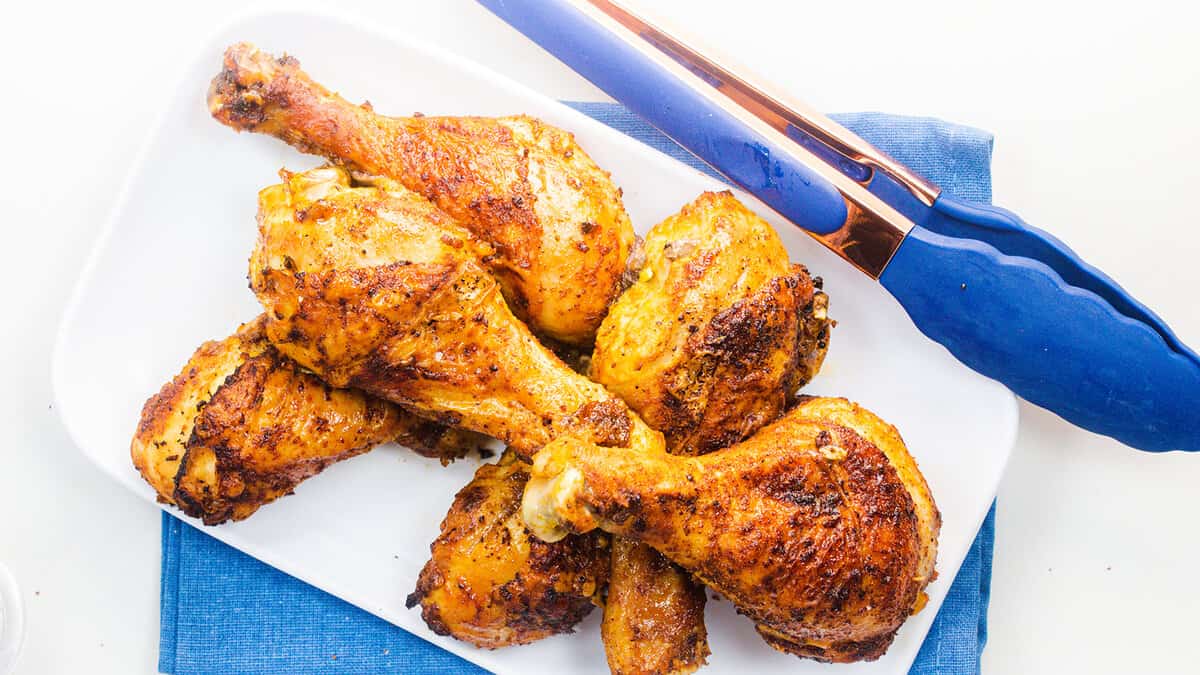 an overhead image of a platter of baked chicken legs.