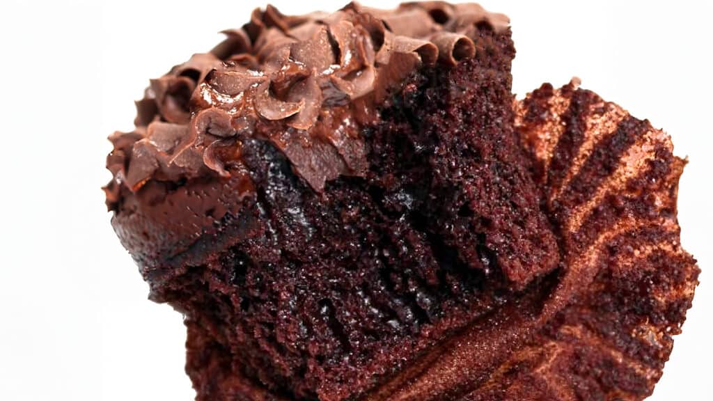 Chocolate cupcake with a bite taken out.