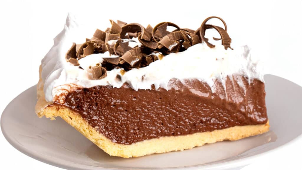 a slice of chocolate pudding pie on a plate with a fork.