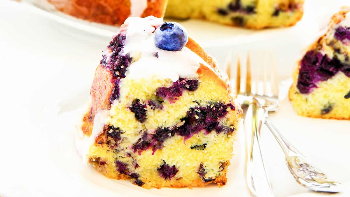 A slice of the cake on a plate with two forks.