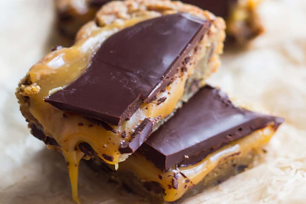 Salted caramel blondies with a chocolate chip cookie base and dark chocolate topping.