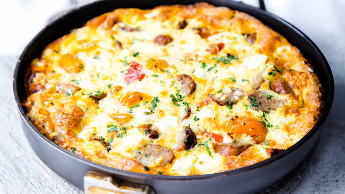 A golden brown Sausage and Egg Frittata with peppers and feta cheese.