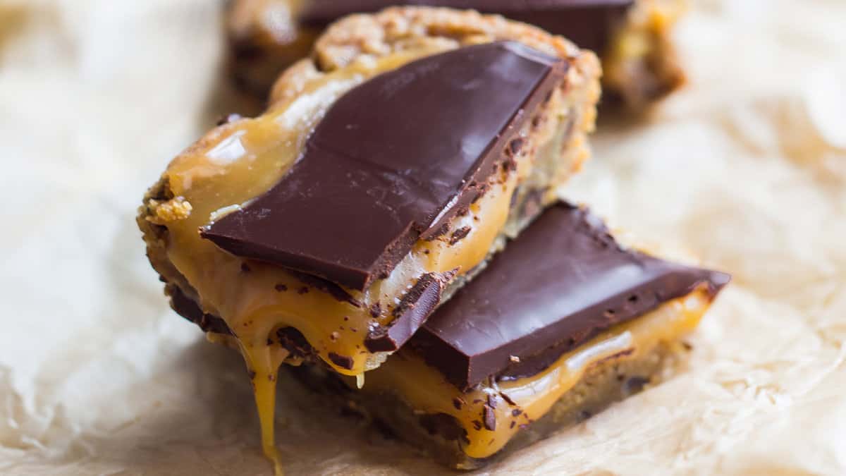 Salted caramel blondies with a chocolate chip cookie base and dark chocolate topping.