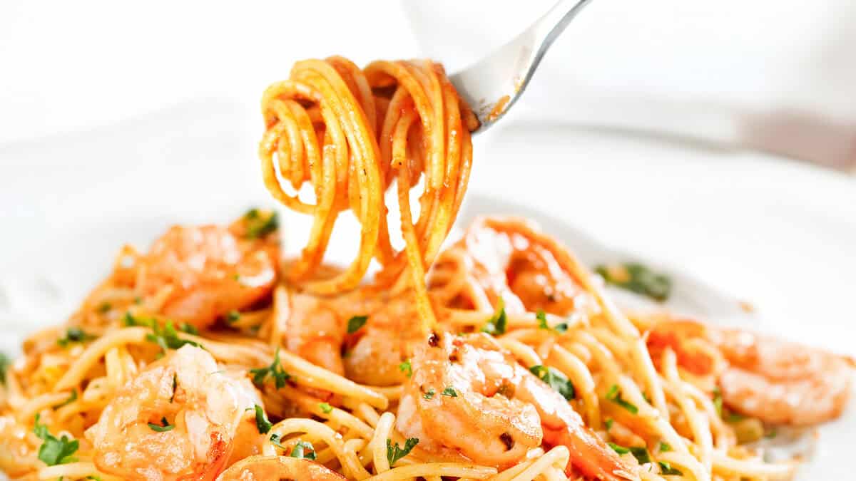 Shrimp spaghetti twirled on a fork.