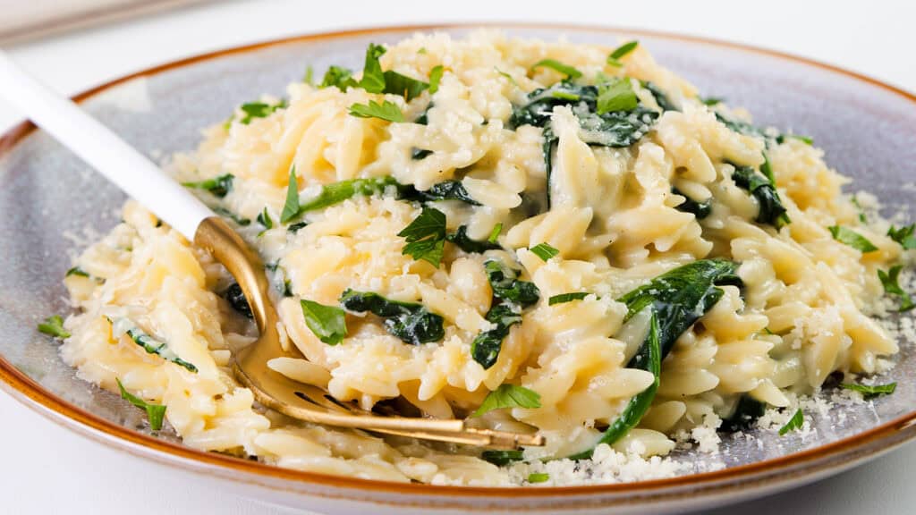 Parmesan Lemon Orzo Pasta in a bowl with a serving spoon.