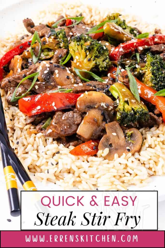 A plate of beef stir-fry with broccoli, mushrooms, red peppers, and white rice