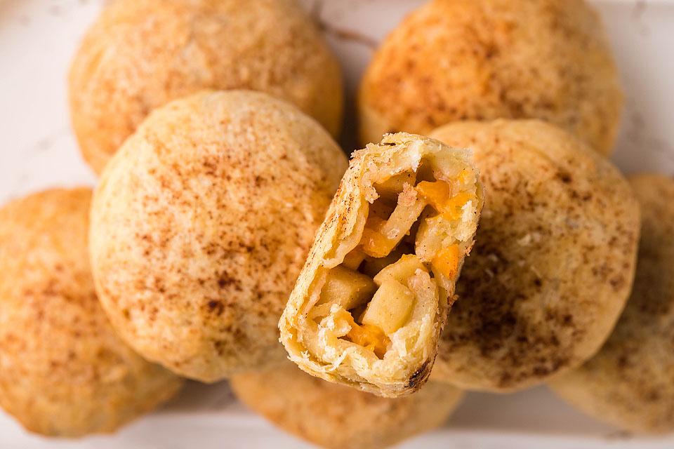 A close up image of a platter of Air Fryer Apricot Apple Cinnamon Dumplings.