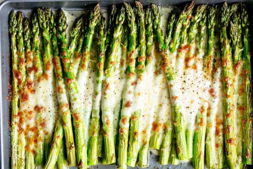 A close up image of a platter of Cheesy Garlic Roasted Asparagus.