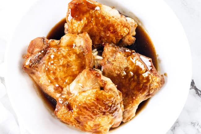 scooping a piece of tuscan chicken from a crockpot.