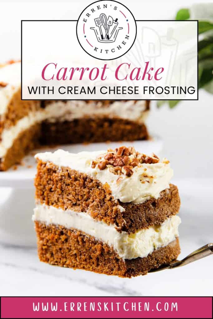 A slice of carrot cake with cream cheese frosting graces a white plate. This delectable cake recipe features two layers topped with chopped nuts. In the softly blurred background, errenskitchen.com is subtly displayed beneath the logo.
