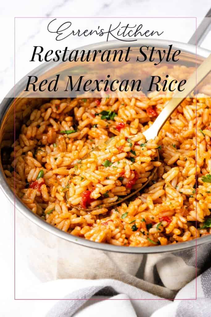 A close-up of a pot filled with restaurant style red Mexican rice, garnished with herbs, and a serving spoon inside. The text overlay reads: “Erren's Kitchen Restaurant Style Red Mexican Rice.”.