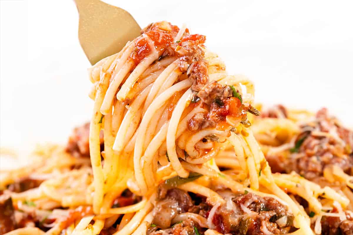 A forkful of Quick & Easy Spaghetti Bolognese ready to eat.