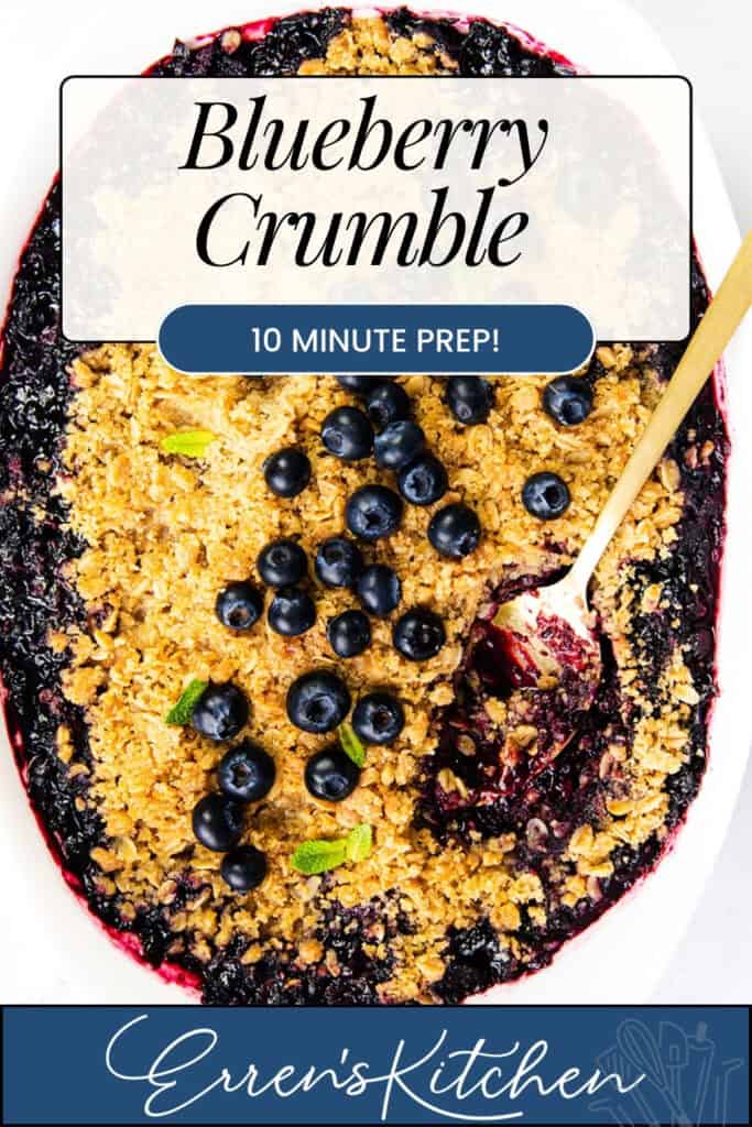 A baked Easy Blueberry Crumble topped with oats and fresh blueberries, featuring a golden, crumbly topping and a spoon scooping out a portion. Text reads: “Easy Blueberry Crumble, 10 Minute Prep! Erren’s Kitchen.”.