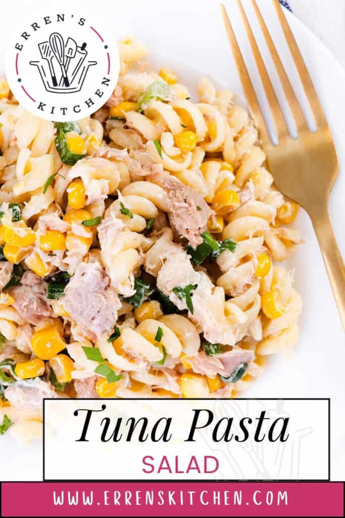 A close-up of Tuna Pasta Salad with rotini pasta, tuna, corn, and fresh herbs on a white plate beside a gold fork. The text reads: "Tuna Pasta Salad" and "www.errenskitchen.com.
