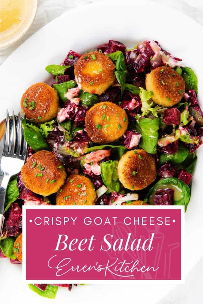 A white plate with beet goat cheese salad, featuring crispy goat cheese rounds atop mixed greens and beets, with a fork on the side. Text overlay reads, "Crispy Goat Cheese Beet Salad Erren's Kitchen.