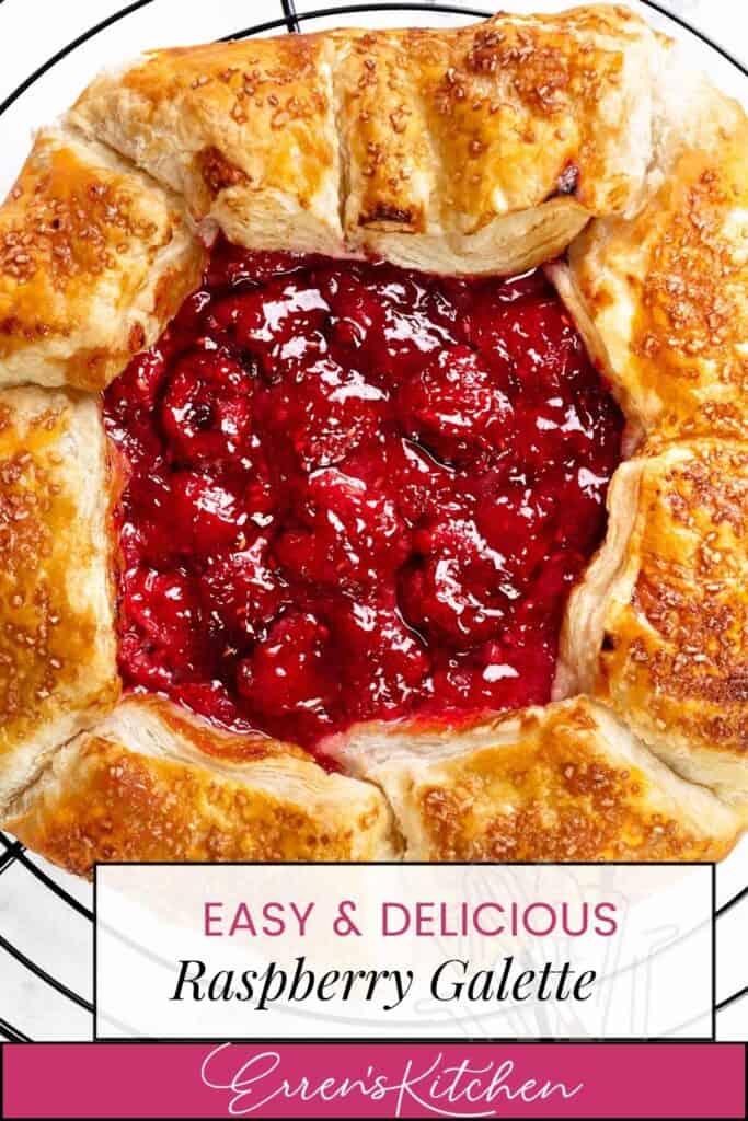 A golden-brown, rustic summer raspberry galette with a flaky crust and juicy raspberry filling sits on a cooling rack. Text reads “Easy & Delicious Raspberry Galette - Erren’s Kitchen.”.
