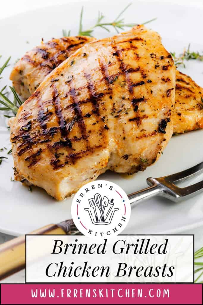 Two grilled chicken breasts with char marks are served on a white plate, garnished with rosemary. A fork rests nearby. The text reads “Juicy Brined Grilled Chicken Breasts” and includes the logo and website for Erren’s Kitchen.