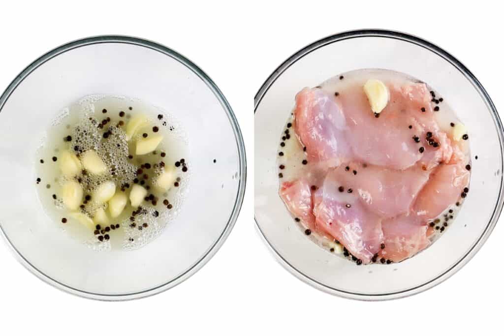 Two glass bowls: one with garlic cloves, black peppercorns, and bubbly liquid; the other with raw chicken pieces soaking in the same brine. Both are ready for making a pickle brined fried chicken sandwich on a white background.