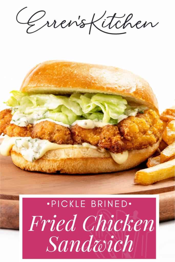 A pickle brined fried chicken sandwich with lettuce and sauce on a bun, served alongside crispy fries on a wooden board. Text reads: "Erren's Kitchen, Pickle Brined Fried Chicken Sandwich.
