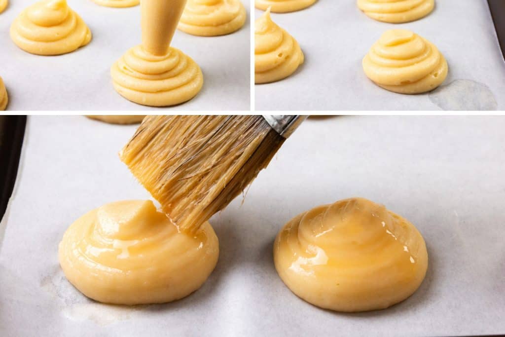 Close-up of choux pastry dough piped onto parchment paper in round shapes, with a pastry brush applying an egg wash to the dough rounds. The process is shown step-by-step in two sections.