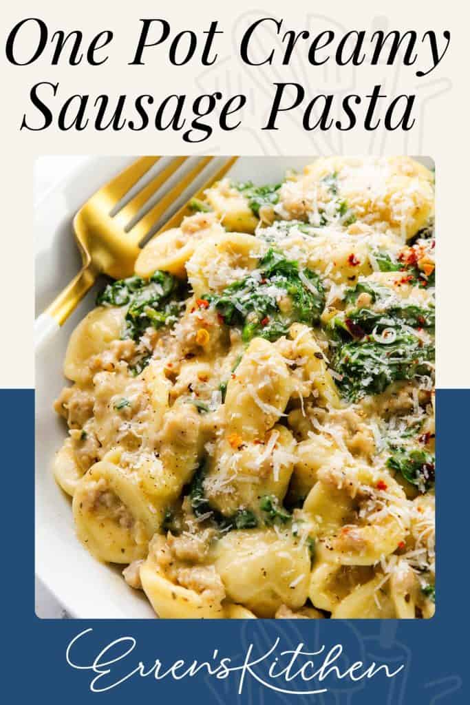 A bowl of creamy sausage pasta with wilted greens, topped with grated cheese and herbs, served with a gold fork. The text reads: “One Pot Creamy Sausage Pasta” and “Erren’s Kitchen.” Perfect for lovers of rich, comforting pasta dishes.