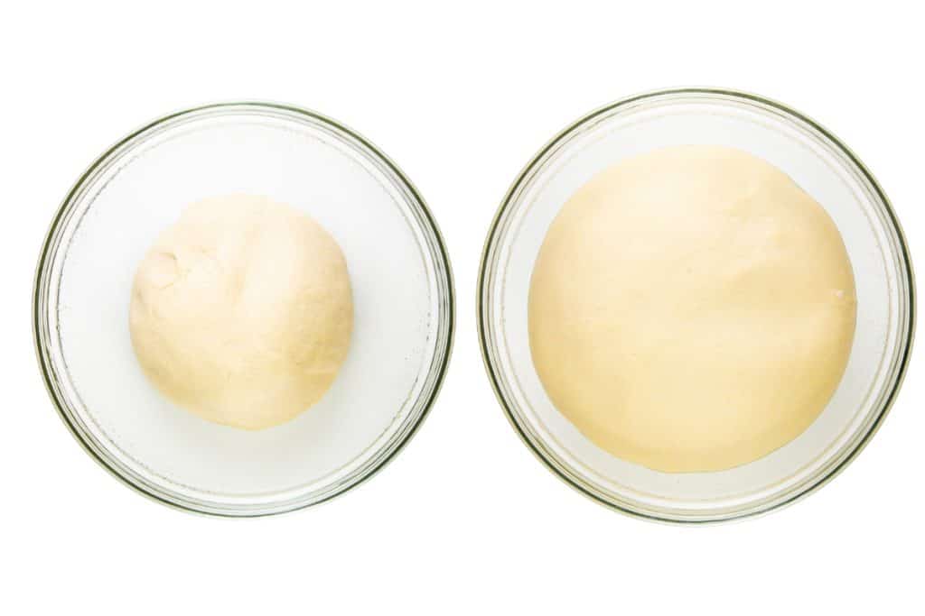 Two glass bowls on a white background: the left holds a small ball of dough, while the right shows dough for garlic focaccia that has risen and doubled in size, ready to be topped with pesto or Parmesan.