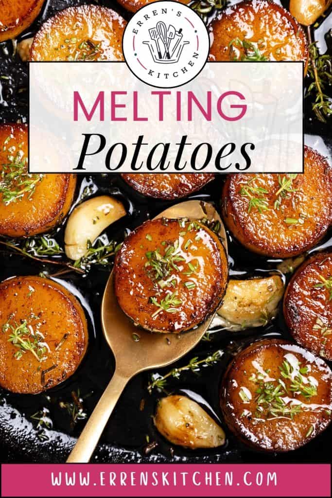 Golden, crispy potatoes and melting potatoes topped with fresh herbs are served in a pan with whole roasted garlic cloves. A spoon lifts one potato. Text overlay reads "Melting Potatoes" and the website errenskitchen.com is shown.