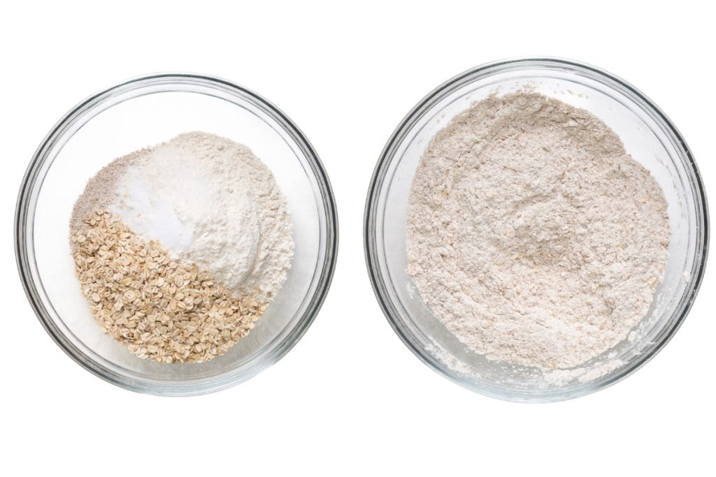 Two glass bowls on a white background; the left bowl displays separated Irish Soda Bread ingredients like oats, flour, and baking powder, while the right bowl shows these ingredients fully mixed together.
