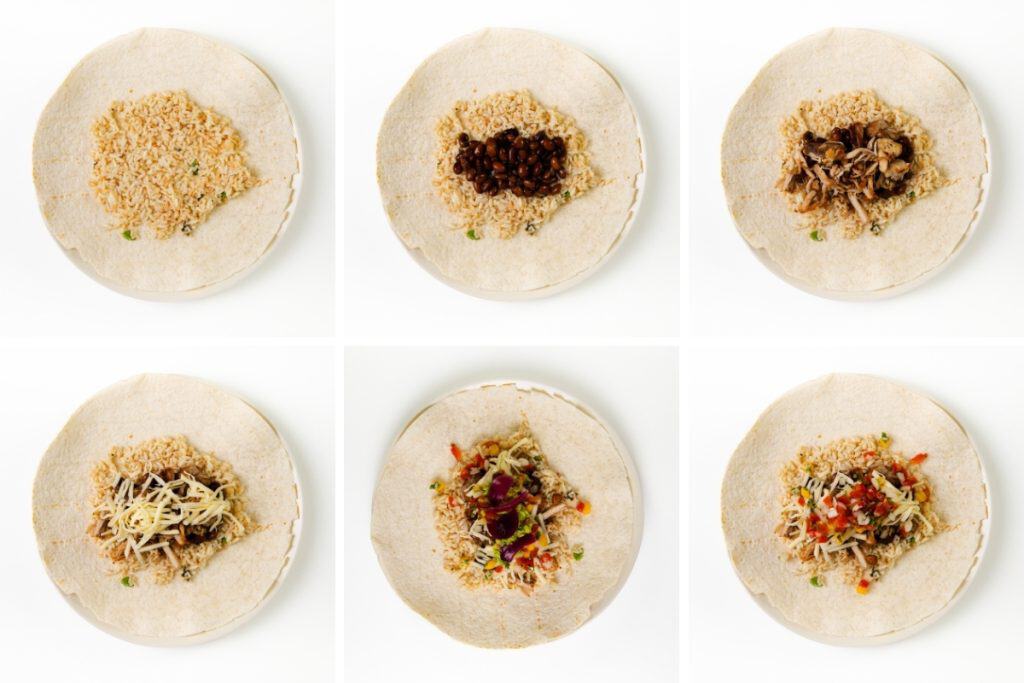 Six steps showing a tortilla being filled for burritos: first with rice, then beans, then slow cooker carnitas, shredded cheese, salsa, and finally chopped tomatoes and cilantro, all on separate plates against a white background.