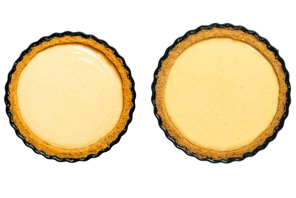 Two round Easy Lemon Pies with golden graham cracker crusts and creamy yellow filling, viewed from above on a white background.